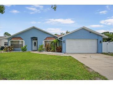 Charming single-Gathering home with a well-manicured lawn and a two-car garage on a sunny day at 12546 108Th St, Largo, FL 33778
