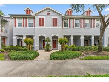 Charming townhome with manicured landscaping, red shutters, and inviting front entrances at 9418 W Park Village Dr # 105, Tampa, FL 33626
