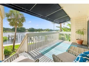Balcony with covered awning overlooking waterfront views and a railing at 2424 W Tampa Bay Blvd # G204, Tampa, FL 33607