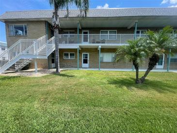 Well maintained two-story condo building with lush landscaping and light-colored exterior at 5247 81St N St # 2, St Petersburg, FL 33709