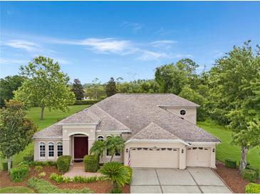Stunning single-story home with a manicured front yard and a three-car garage at 7244 Wild Oak Ln, Land O Lakes, FL 34637