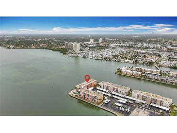 Stunning aerial view of waterfront condos with bay views and surrounding landscape at 7665 Sun Island Dr # 206, South Pasadena, FL 33707