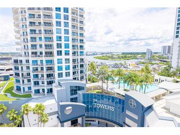 Close aerial view of white high-rise towers with private balconies and a beautiful pool area at 1209 E Cumberland Ave # 1003, Tampa, FL 33602