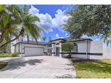 Charming single-story home featuring a two-car garage, manicured landscaping, and a welcoming front entrance at 1218 Willow Bend Way, Lutz, FL 33549