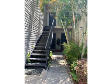 Exterior view of property entrance with tropical landscaping at 7821 Niagara Ave # 2102, Tampa, FL 33617