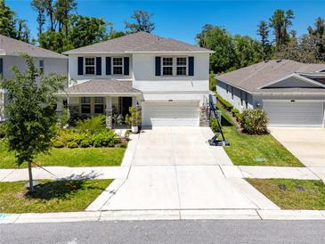 Beautiful two-story home with a well-manicured lawn and a two-car garage at 8423 Praise Dr, Tampa, FL 33625