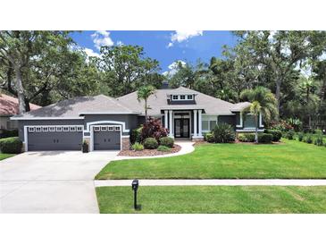 Beautiful single-story home featuring a well-manicured lawn, attached garage, and a welcoming front entrance at 15024 Eaglepark Pl, Lithia, FL 33547