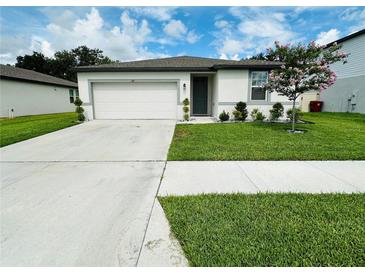 Charming single-story home with a well-manicured lawn, and a two car garage at 219 Lovely Ct, Plant City, FL 33566