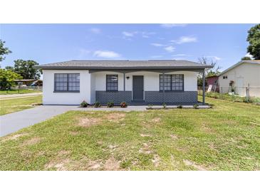 Charming single-story home featuring a freshly painted exterior and well-maintained front lawn at 2425 Wishing Well Cir, Tampa, FL 33619