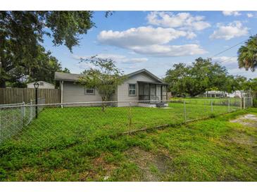 Charming single-story home with a fenced yard and a cozy screened-in porch for relaxing outdoors at 2607 N 59Th St, Tampa, FL 33619