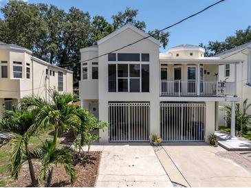 Inviting multi-level home with large windows, gated entry, and well-maintained landscaping at 3412 W San Juan St # A, Tampa, FL 33629