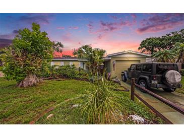 Charming single-story home with a lush green lawn and mature landscaping, offering great curb appeal at 5643 86Th N Ave, Pinellas Park, FL 33782