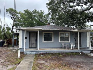 Charming single-story home with a cozy front porch and mature shade trees in a residential neighborhood at 2354 7Th S St, St Petersburg, FL 33705