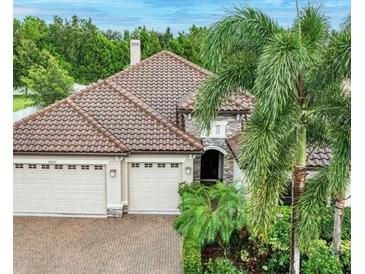 Charming home with a tile roof, two-car garage and beautiful landscaping at 14807 Bowfin Ter, Lakewood Ranch, FL 34202