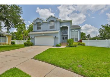 Charming two-story home featuring manicured lawn, two-car garage and beautifully arched entryway with decorative windows at 3633 Springville Dr, Valrico, FL 33596
