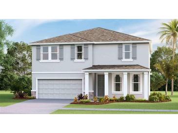 Charming two-story home with a neutral color scheme, attached garage, and well-maintained front yard at 6413 Gladeview Way, Land O Lakes, FL 34638