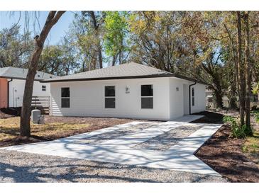 Charming single-story home featuring a well-manicured yard and a concrete driveway that adds curb appeal at 10219 Huntley St, New Port Richey, FL 34654