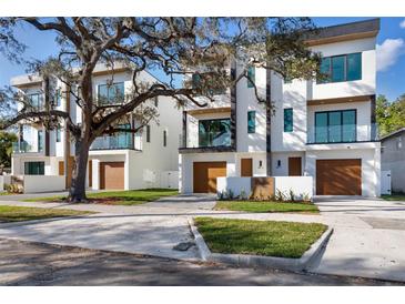 Modern townhomes boast clean lines, balconies, and wood-look garage doors at 115 W Gladys St # 2, Tampa, FL 33602