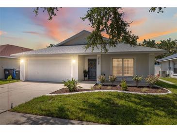 Charming single Gathering home with a two-car garage, manicured lawn, and a welcoming entrance at 2108 Delightful Dr, Ruskin, FL 33570