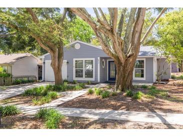 Charming single-story home with mature trees, blue accents, and well-maintained landscaping at 2770 Steeple Ct, Palm Harbor, FL 34684