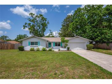 Charming single-story home featuring a well-manicured lawn and inviting curb appeal at 3849 Hollow Oak Pl, Land O Lakes, FL 34639