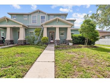 Charming two-story townhome with a well-manicured lawn and inviting entrance at 6934 Duffy Ln, Tampa, FL 33616