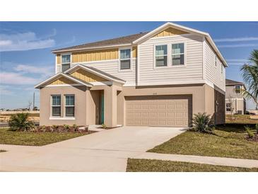 Two story home with neutral color palette, attached garage, and manicured landscaping at 14819 Summer Branch Dr Dr, Lithia, FL 33547