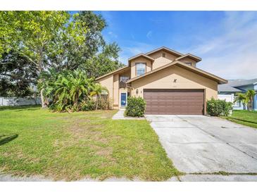 Charming two-story home featuring a well-manicured lawn and mature landscaping at 1715 Larabie Ct, Brandon, FL 33511