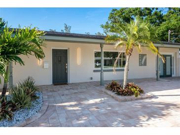 Stylish home exterior displaying modern lighting, fresh landscaping, and a gray front door at 243 45Th Ne Ave, St Petersburg, FL 33703