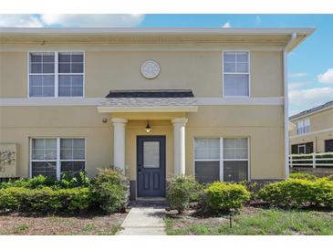 Inviting two-story home with a covered entryway, lush landscaping, and a charming architectural design at 3406 Dragon View Ct, Valrico, FL 33594