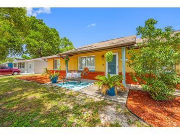 Charming home with a cozy front porch, colorful landscaping, and a welcoming entrance at 5236 Madison St, New Port Richey, FL 34652