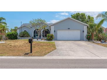 Charming single-story home with a two-car garage, manicured landscaping, and a well-maintained lawn at 832 Birdie Way, Apollo Beach, FL 33572