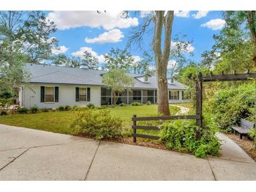 Charming single-story home with a lush front yard and a welcoming walkway at 15234 Scanio Dr, Spring Hill, FL 34610