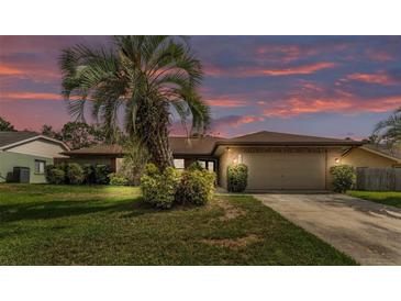 Charming single-story home featuring lush landscaping, mature trees, and an attached two-car garage at 1901 Paddock Dr, Plant City, FL 33566