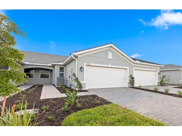 Beautiful single Gathering home with a neutral paint scheme, 2-car garage, and manicured landscaping at 27132 Capri Shores Cir, Englewood, FL 34223