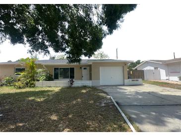 Charming single-story home featuring an attached garage and well-lit exterior at 4374 32Nd N Ter, St Petersburg, FL 33713