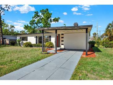 Charming single-story home featuring a carport, landscaped yard and a freshly painted exterior at 4379 Porpoise Se Dr, St Petersburg, FL 33705