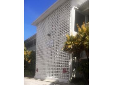 The exterior showcases the architectural details of Disston Arms beneath clear blue skies at 5155 9Th N Ave # 311, St Petersburg, FL 33710