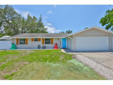 Inviting single-Gathering home features a two-car garage and an eye-catching blue front door at 540 Firefly Ln, Apollo Beach, FL 33572