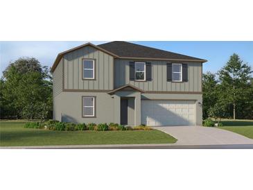 Two-story home boasts a modern exterior with gray siding and a two-car garage at 5676 Red Kite Dr, Wimauma, FL 33598