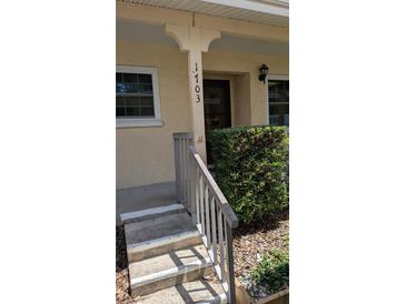 Inviting home entrance with neat landscaping, a well-lit porch, and clear house number display at 2465 Northside Dr # 1703, Clearwater, FL 33761