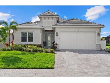 Charming home with a well-manicured lawn, light-colored siding, and a two-car garage at 271 Monet Trl, Bradenton, FL 34212