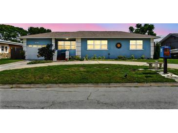 Charming single story home with a large circular driveway and well-manicured lawn at 4211 28Th N Ave, St Petersburg, FL 33713
