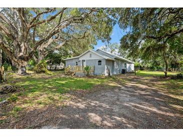 Charming single-story home featuring a new deck, mature trees, and fresh exterior paint at 44912 Lacoochee Claysink Rd, Webster, FL 33597