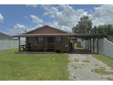 Charming single-story home featuring a covered porch, carport, and a compact front yard at 5807 N Hale Ave, Tampa, FL 33614