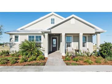 Charming single-story home featuring a covered porch with columns and a beautifully landscaped front yard at 7621 Highgrove Ave, Bradenton, FL 34210