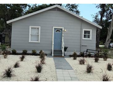 Charming single-story home with a light blue door and tidy landscaping at 921 Grand Central St, Clearwater, FL 33756