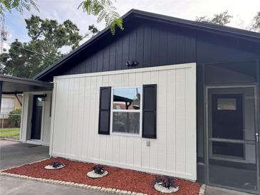 Charming home featuring a black and white exterior and neatly landscaped front yard at 1005 S Empire St, Plant City, FL 33563