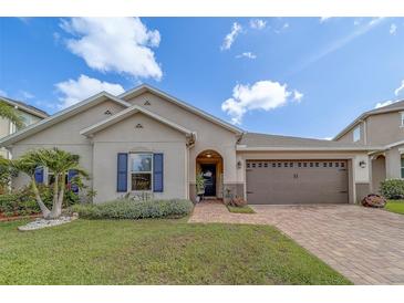 Charming home with brick walkway, two-car garage, well-manicured lawn, and appealing curb appeal at 11327 Brighton Knoll Loop, Riverview, FL 33579