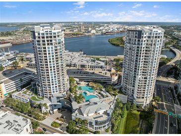 Stunning aerial view of luxury condo towers with pool and city skyline backdrop on a sunny day at 1209 E Cumberland Ave # 604, Tampa, FL 33602